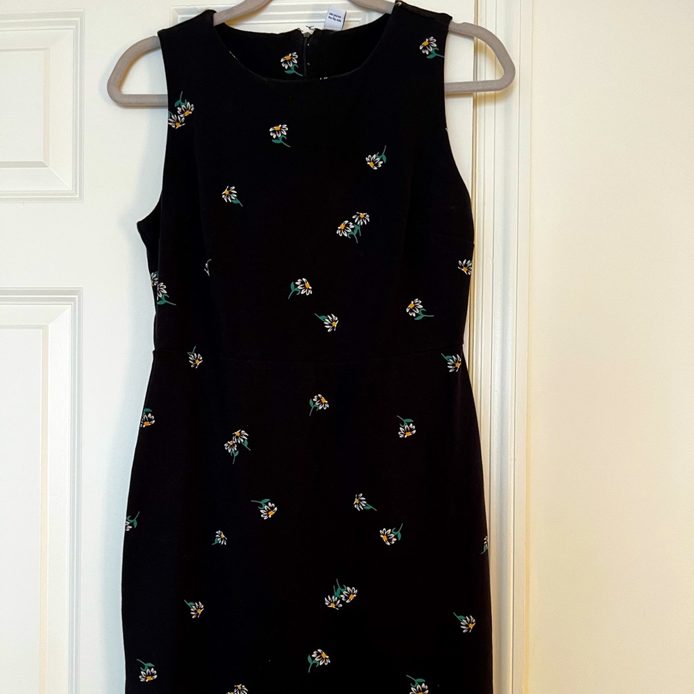 Fitted, navy, high-neck, sleeveless dress.